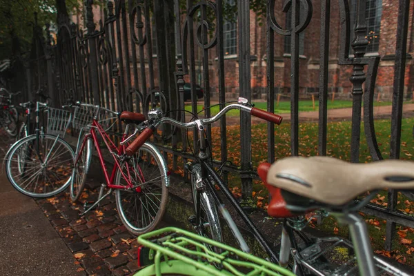 Selective focus of bicycles near fencing on urban street in Copenhagen, Denmark — Stock Photo