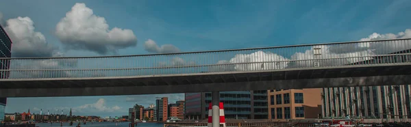 Panoramic shot of bridge with buildings and cloudy sky at background in Copenhagen, Denmark — Stock Photo