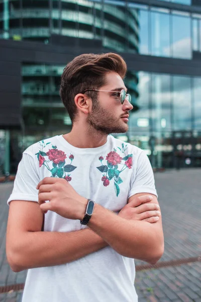 Handsome man in sunglasses looking away on urban street — Stock Photo