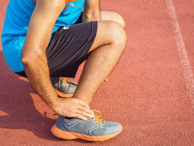 Atlet adamın ayak bileği yaralanması, eğitim çalışan sırasında burkulan bacak var. Sağlık ve spor kavramı.