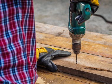 Marangoz bir elektrikli matkapla delik matkap. Meslek, doğrama, doğrama ve insanlar kavramı.