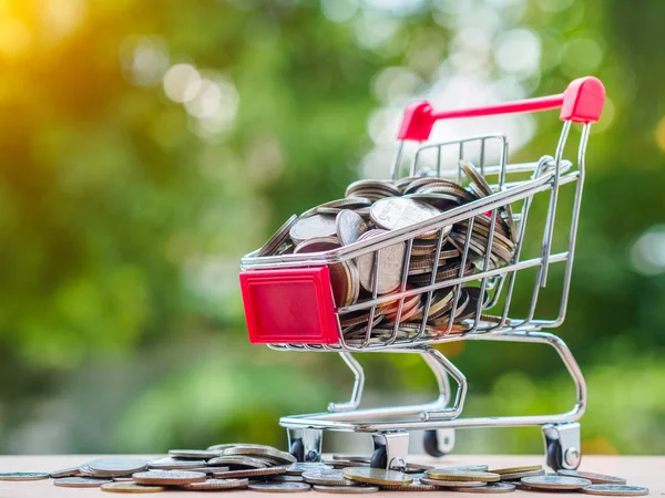 Madeni para ile alışveriş arabası. tasarruf, konsept alışveriş için para harcamak.