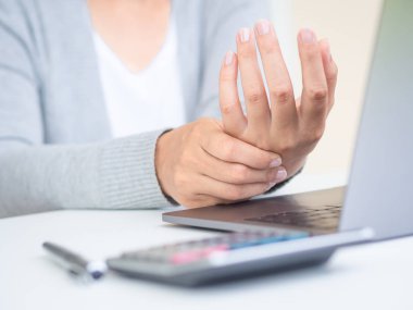 Bilgisayar uzun süre kullanarak el acısını tutan Closeup kadın. Office sendromu kavramı. istimal bilgisayar uzun zaman acı cektim. Office sendromu kavramı.