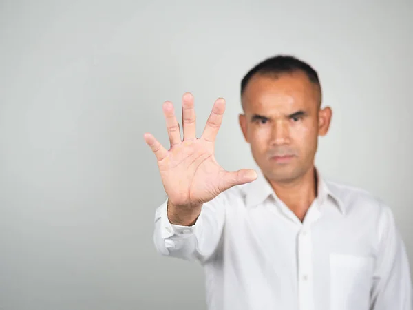 The man showing hand gesture stop sign isolated on white backgro