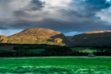 A beautiful landscape with a mountain and cloudy sky