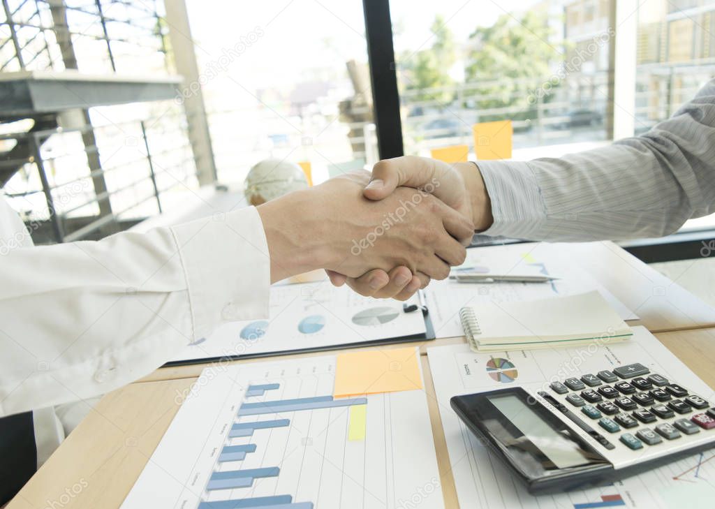 Both businessmen shake hands successfully with more than twice t
