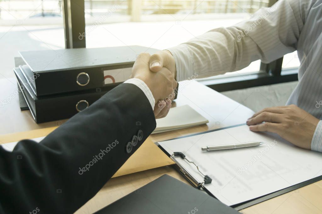 Both businessmen shake hands successfully with more than twice t