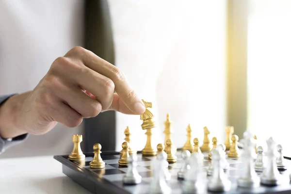 A young business man is playing chess, business strategy to be s — Stock Photo, Image