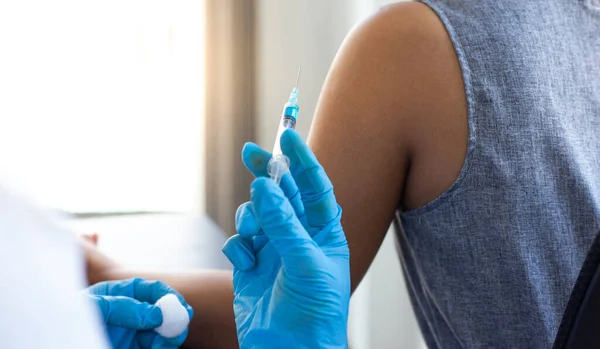 Vaccination of patients, Doctor provided a vaccine with a syringe against a new strain of  virus or influenza in a modern hospital, Prevention and health care concept.