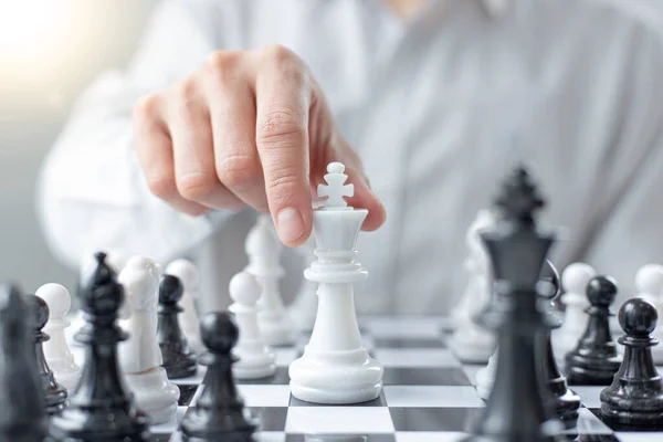 Business men make plans to play chess with Prudence and success, Management or leadership concept.