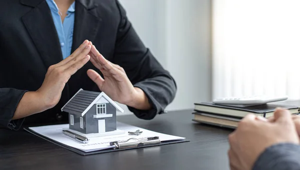 Real estate agent or sales manager has offered home sales and explained the terms of signing the house purchase contract and free home insurance, Finance and after-sales service concept