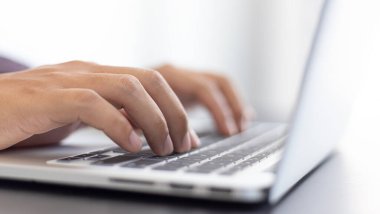 İş adamının elinin yandan görünüşü toplantı odasında bir dizüstü bilgisayar yazmak, modern teknoloji ve tam internet sistemleri kavramı..