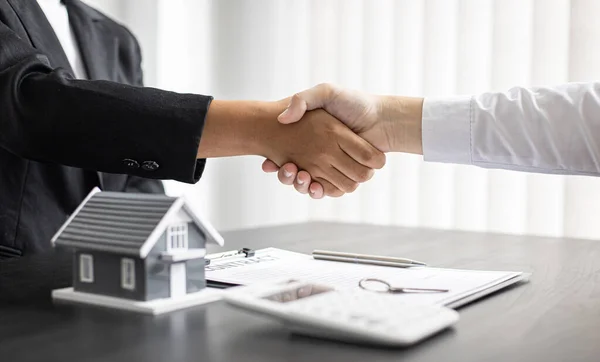 Property manager Shake hands with congratulations on the customers who bought the house with insurance, Hand shake, Success and congratulations concept.