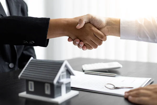 Property manager Shake hands with congratulations on the customers who bought the house with insurance, Hand shake, Success and congratulations concept.