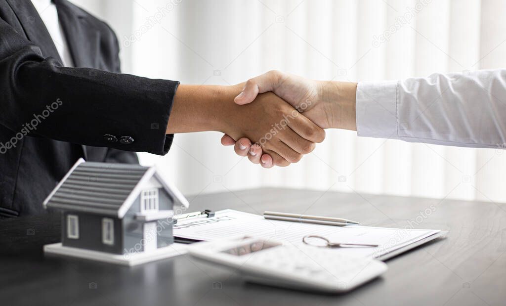 Property manager Shake hands with congratulations on the customers who bought the house with insurance, Hand shake, Success and congratulations concept.
