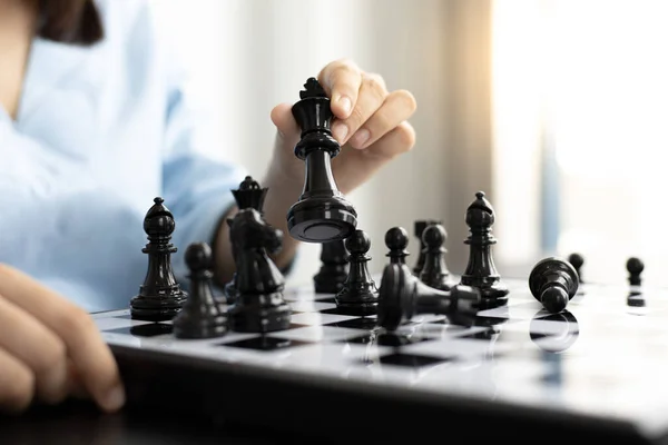 Business people are planning marketing strategies by analyzing the mechanisms and probability of the market by using chess to work, Playing chess for business concept.