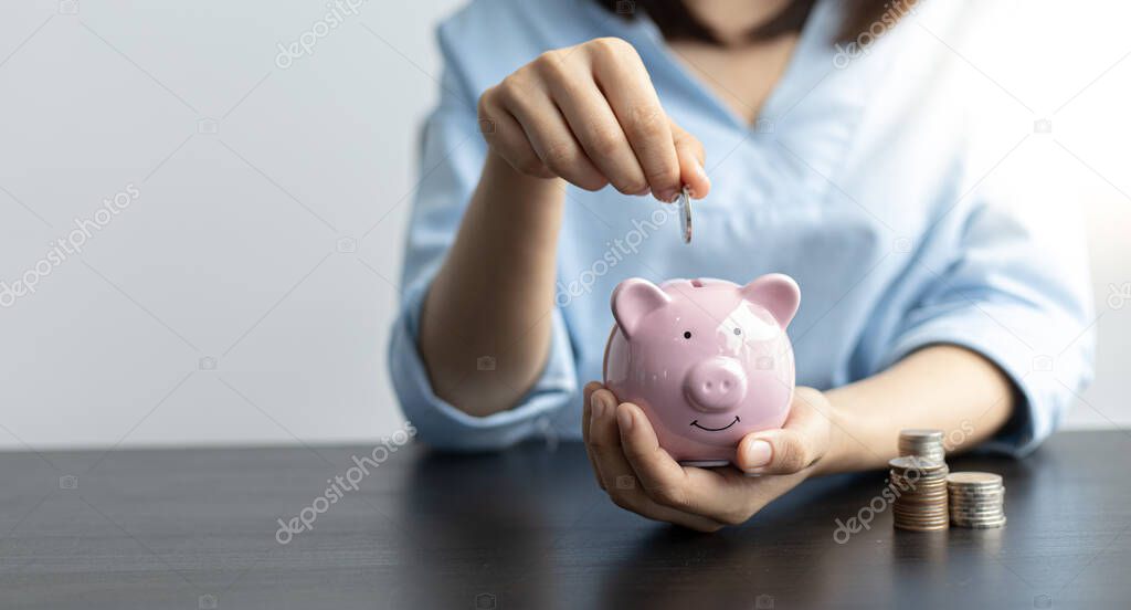 Young woman is saving money and calculating the income and expenses of the house due to the poor economic situation which makes saving money, Save money concept.