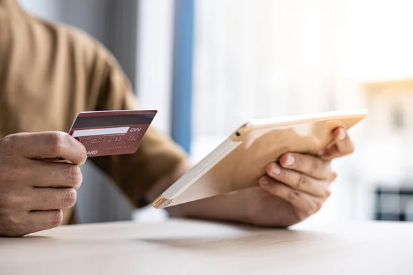 Businessman use tablet to register for security Online with a credit card to buy products online through application, Online shopping or Internet technology concept.