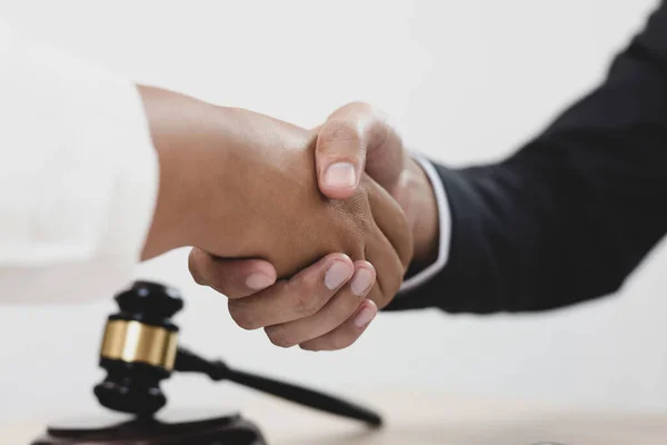 Lawyers or counselors join hands with clients to congratulate the end of the case by the company, Negotiation or settlement of lawsuits concept.