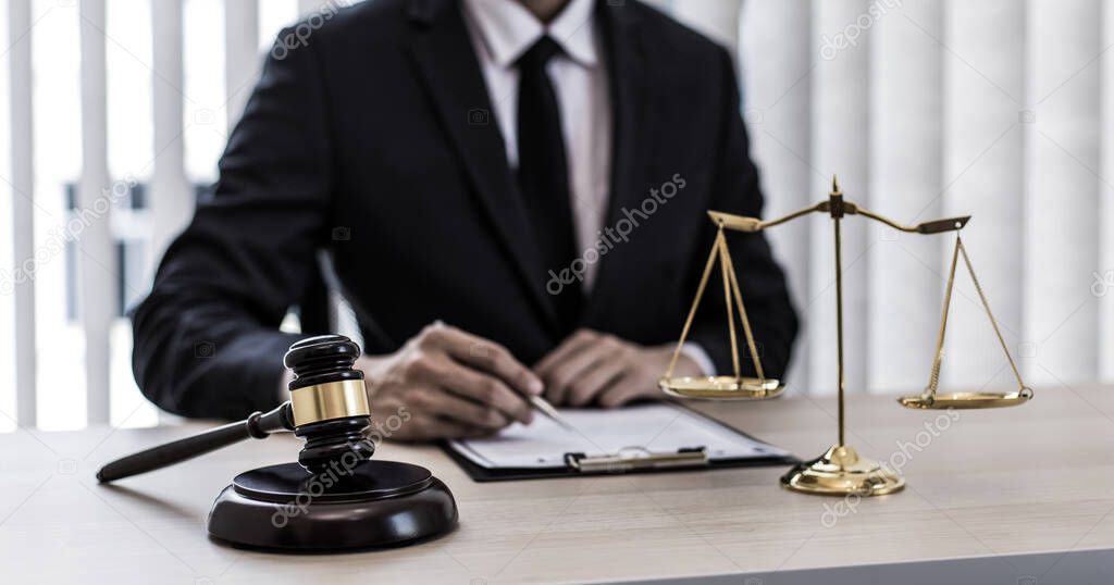 Judge or a lawyer works documents in the courtroom and analyze the various laws for justice and accuracy, Litigation and justice concept.