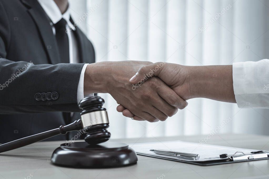 Lawyers or counselors join hands with clients to congratulate the end of the case by the company, Negotiation or settlement of lawsuits concept.