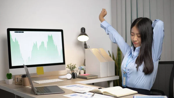 Asian businesswoman is relaxing after overtime working in a office, Happy women resting at work after work is finished.