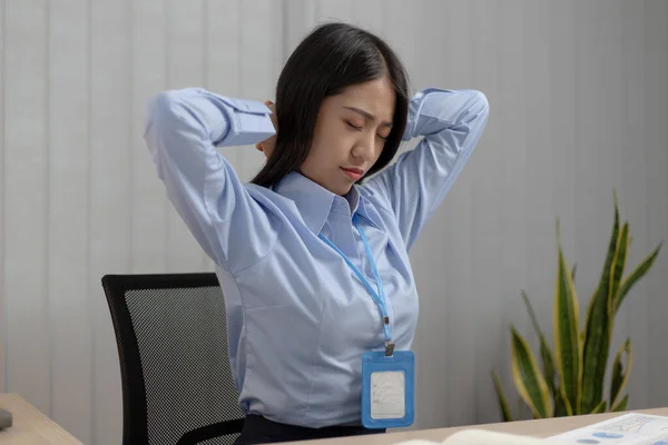 Asian businesswoman is relaxing after overtime working in a office, Happy women resting at work after work is finished.