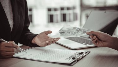 İşadamları, yasadışı arazi ve gayrimenkul, iş dolandırıcılığı ve sosyal adaletsizlik, yolsuzluk ve rüşvet kavramını satın almak için sözleşmeler imzalayan çalışanlara dolar dağıtıyor.