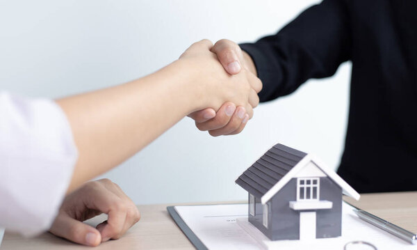 Property manager Shake hands with congratulations on the customers who bought the house with insurance, Hand shake, Success and congratulations concept.