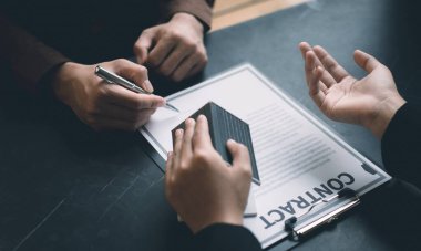 Emlakçı ya da satış müdürü, ev satın alma anlaşmalarını sigorta ile imzalayan müşterilere satın alma sözleşmesini imzalama şartlarını ve şartlarını önerdi..