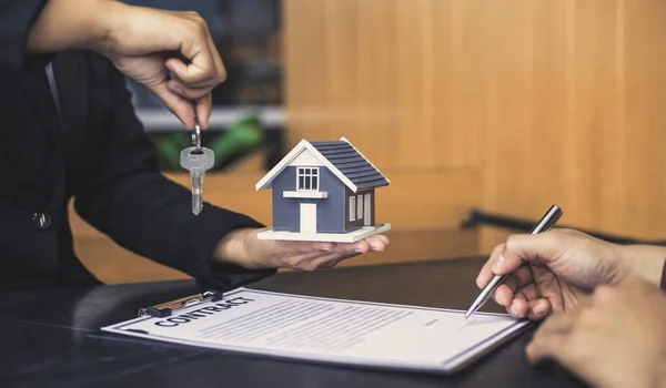 Real estate agent or sales manager has proposed terms and conditions to customers who sign house purchase agreements with insurance, Agreement to sign the purchase contract concept.