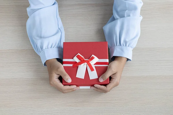 Young man\'s hand holds a gift box to a young woman on festival day, Christmas surprise, New year\'s surprise, Surprise important day, Birthday surprise, Gift box.