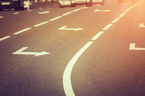 Right arrows on the asphalt of the highway