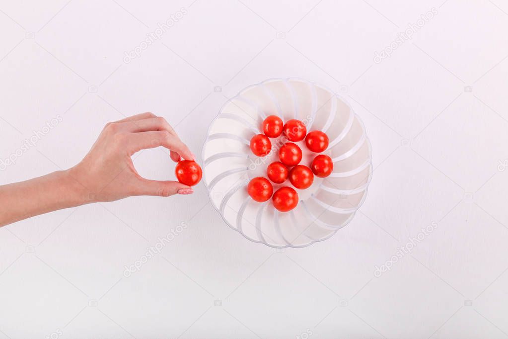 Tomato. White plate with cherry tomatoes