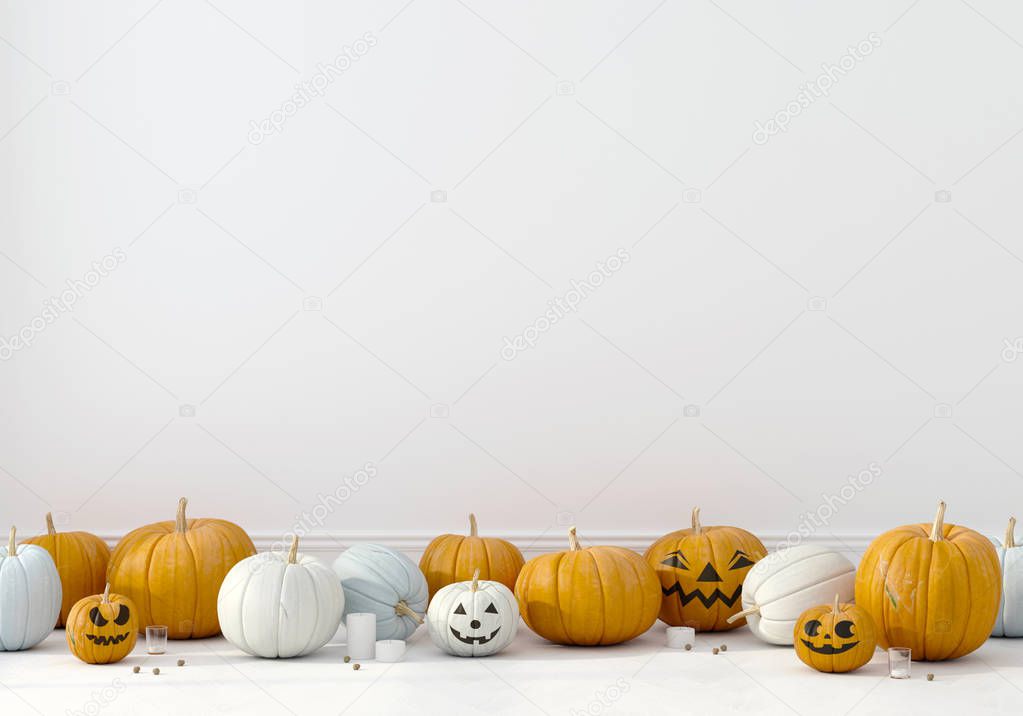 Pumpkins with funny faces on a white wall background 