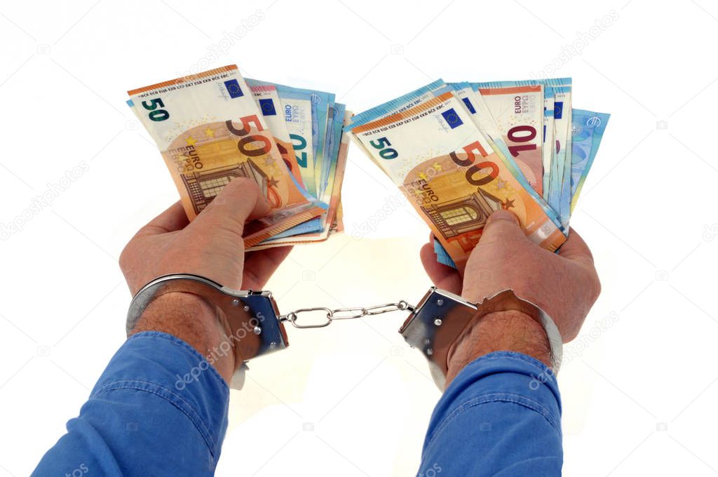 Handcuffed hands with euro banknotes on a white background 