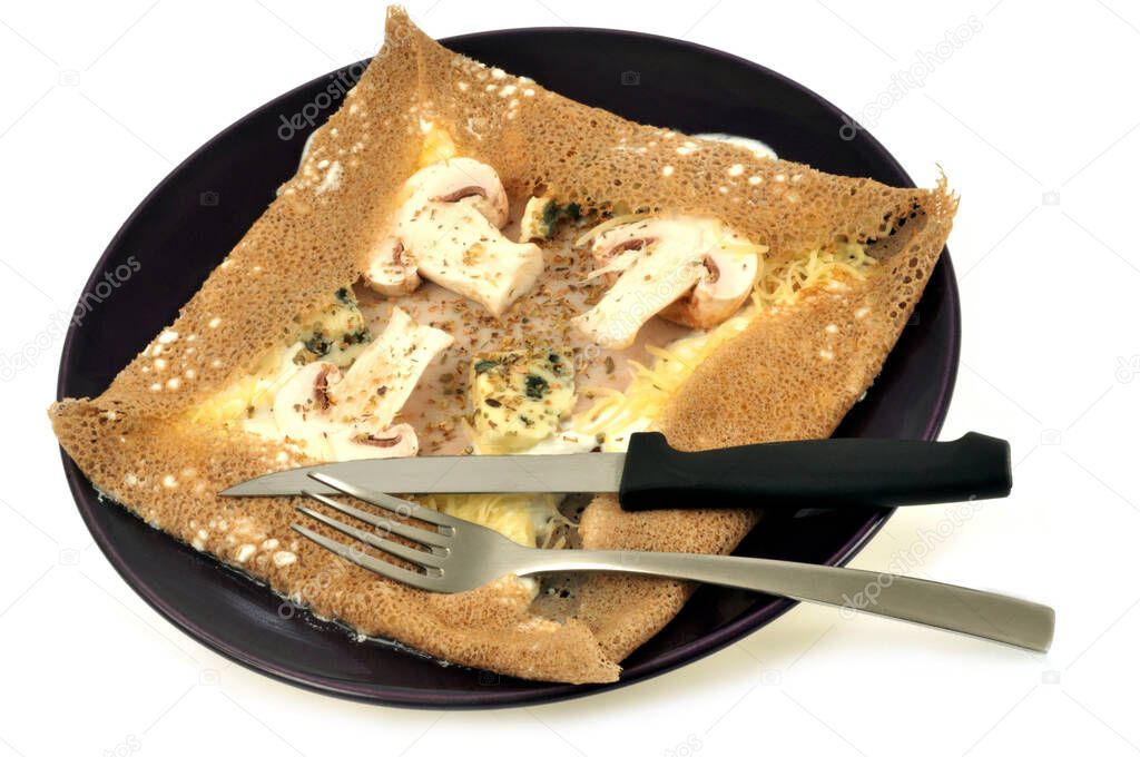 Galette with mushrooms and cheese served on a plate 