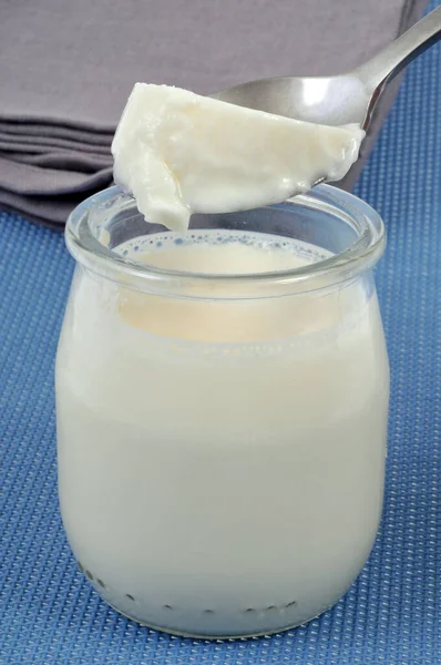 Plain yogurt in glass jar close up