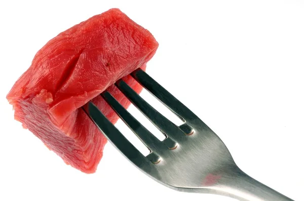 Piece Raw Beef Meat Pitted Fork Close White Background — Stock Photo, Image