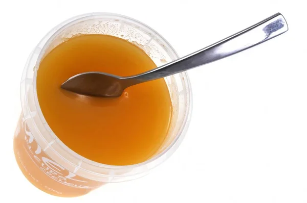 Plastic Jar Honey Spoon Close White Background — Stock Photo, Image