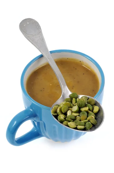 Cup of homemade split pea soup close up with a spoon on white background — Stock Image Cup Homemade Split Pea Soup Close Spoon White Background Stock Photo