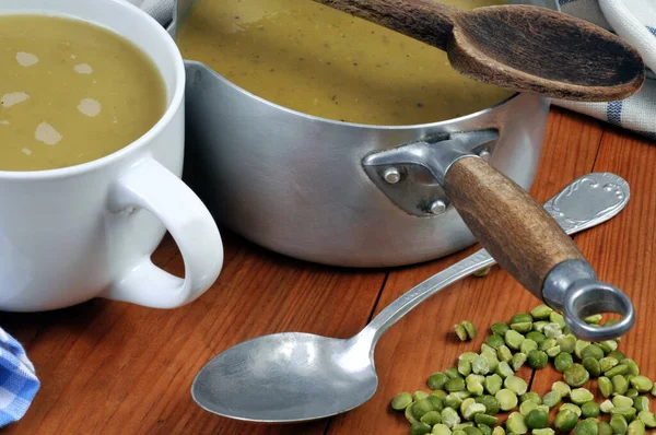 Casserole and bowl of homemade split pea soup with spoon close-up — Stock Image Casserole Bowl Homemade Split Pea Soup Spoon Close Stock Picture
