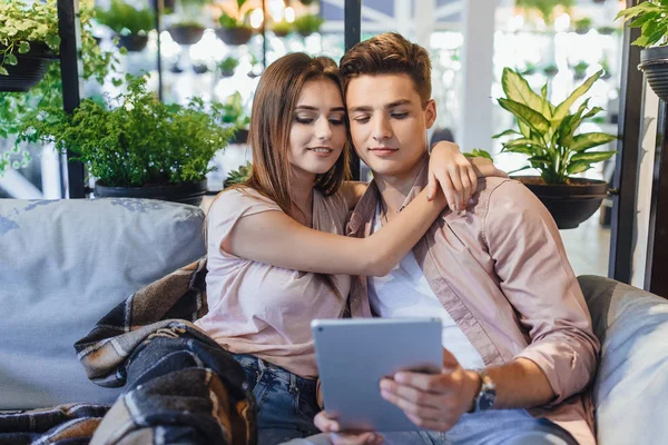 Ungt Par Casual Kläder Sommarterrassen Tittar Surfplatta — Stockfoto