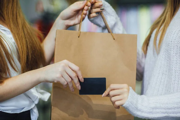 Woman charged for purchasing credit card on background of gift package