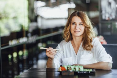 güzel sarışın kadın Japon restoranında yemek 