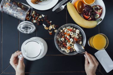 Düz ay çöreği, portakal suyu ve siyah arka plan üzerine kaşık kadın el koyma