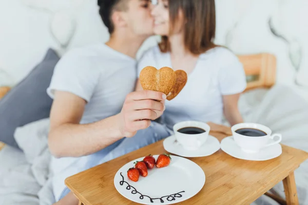 Young Couple Eating Biscuits Form Heart Coffee Bed — Stock Photo, Image