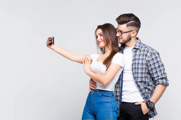 Paar Staande Omarmen Houden Van Mobiele Telefoons Geïsoleerd Witte Achtergrond — Stockfoto