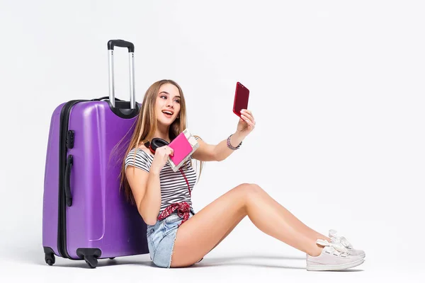young woman with suitcase and passport isolated on white background