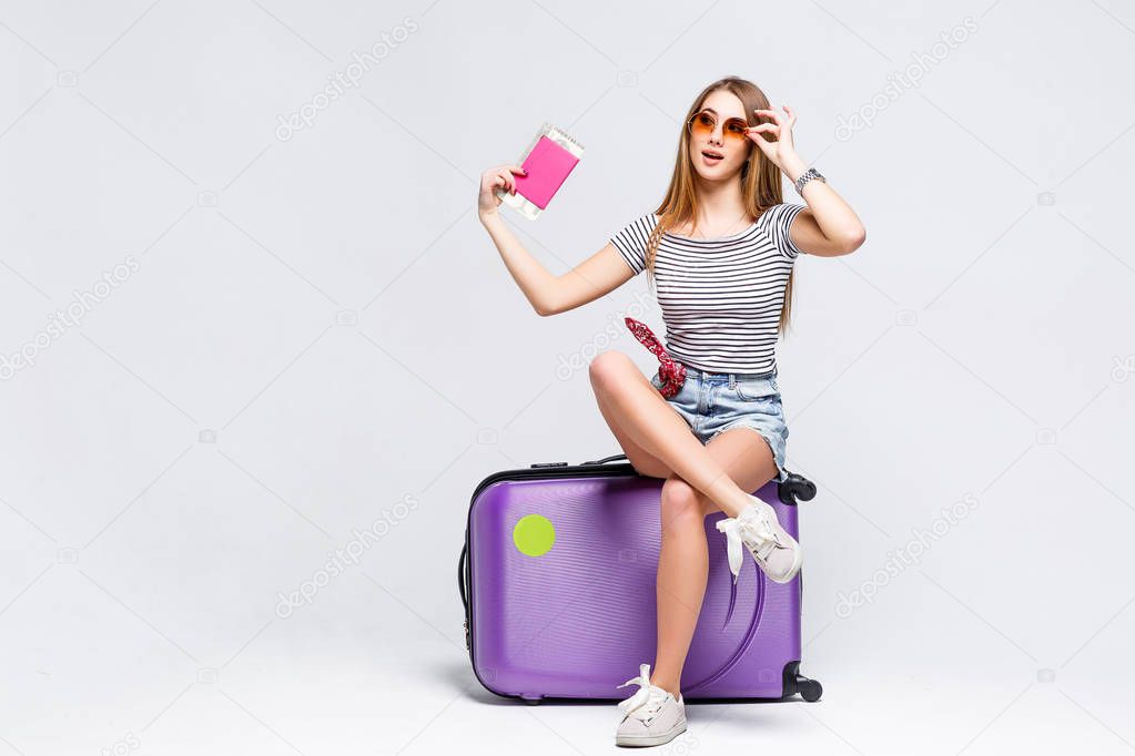 Woman preparing for summer vacation with violet suitcase isolated on white background